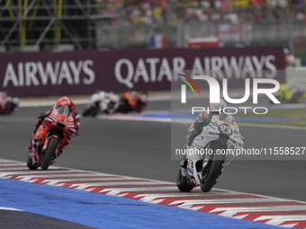 Marc Marquez rides on track in front of Francesco Bagnaia of Italy and the Ducati Lenovo Team during the Race of MotoGP of San Marino at Mis...