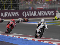 Marc Marquez rides on track in front of Francesco Bagnaia of Italy and the Ducati Lenovo Team during the Race of MotoGP of San Marino at Mis...