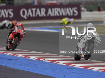 Marc Marquez rides on track in front of Francesco Bagnaia of Italy and the Ducati Lenovo Team during the Race of MotoGP of San Marino at Mis...