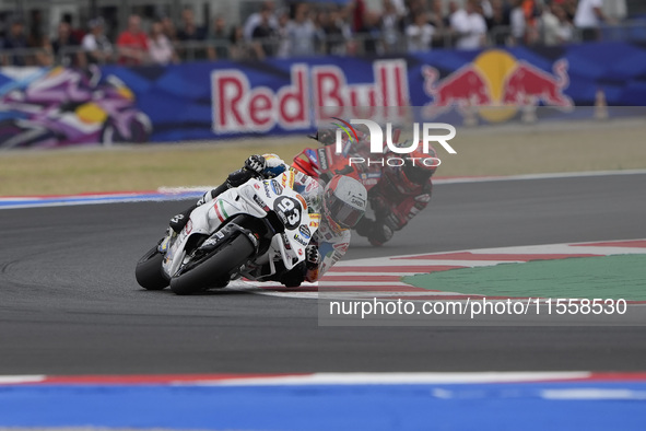 Marc Marquez rides on track in front of Francesco Bagnaia of Italy and the Ducati Lenovo Team during the Race of MotoGP of San Marino at Mis...