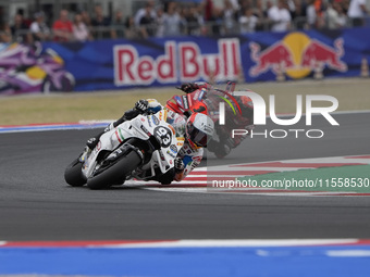 Marc Marquez rides on track in front of Francesco Bagnaia of Italy and the Ducati Lenovo Team during the Race of MotoGP of San Marino at Mis...