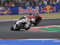 Marc Marquez rides on track in front of Francesco Bagnaia of Italy and the Ducati Lenovo Team during the Race of MotoGP of San Marino at Mis...