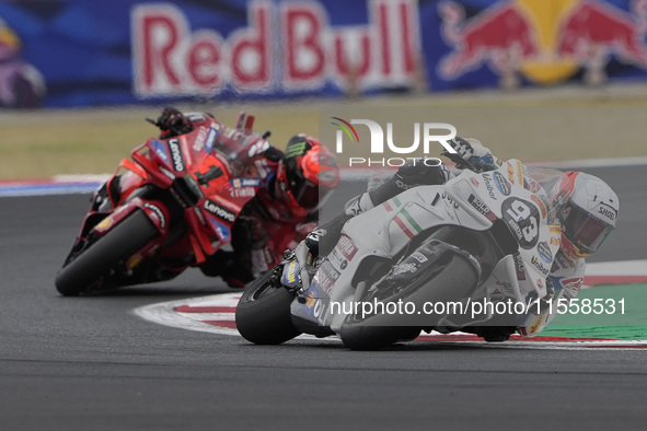 Marc Marquez rides on track in front of Francesco Bagnaia of Italy and the Ducati Lenovo Team during the Race of MotoGP of San Marino at Mis...