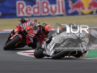 Marc Marquez rides on track in front of Francesco Bagnaia of Italy and the Ducati Lenovo Team during the Race of MotoGP of San Marino at Mis...