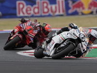 Marc Marquez rides on track in front of Francesco Bagnaia of Italy and the Ducati Lenovo Team during the Race of MotoGP of San Marino at Mis...