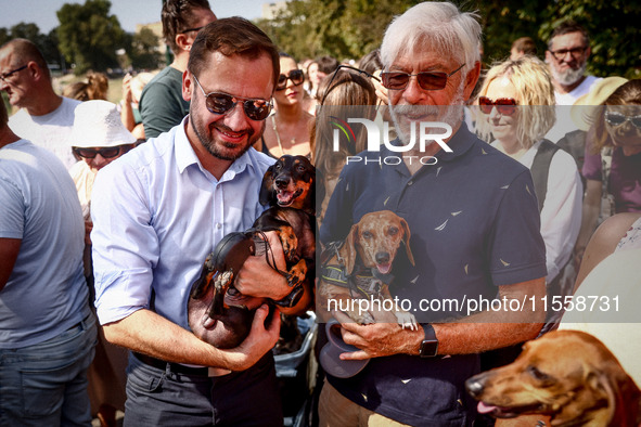 Aleksander Miszalski (left), a major of the city of Krakow, and his dog Muffin, attend the 26th Dachshund March in Krakow, Poland on Septemb...