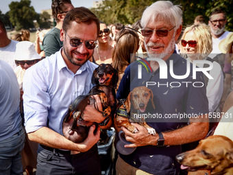 Aleksander Miszalski (left), a major of the city of Krakow, and his dog Muffin, attend the 26th Dachshund March in Krakow, Poland on Septemb...