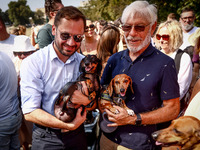 Aleksander Miszalski (left), a major of the city of Krakow, and his dog Muffin, attend the 26th Dachshund March in Krakow, Poland on Septemb...