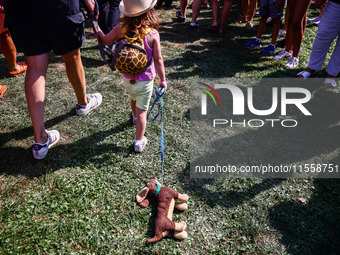 A child with a toy attends the 26th Dachshund March in Krakow, Poland on September 8th, 2024. After a few years break an annual parade  retu...