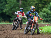 Mark Whitingham (11) leads Georgina Richardson (13) in the Adult Motocross Support Class during the ACU British Upright Championships in Gaw...