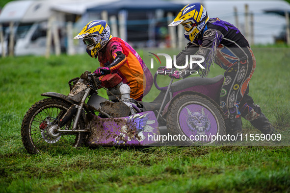 Clint Blondel and Max Chadwick (10) attempt to push start their machine in the mud in the 1000cc Sidecar Class during the ACU British Uprigh...