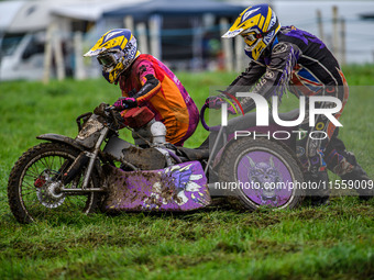 Clint Blondel and Max Chadwick (10) attempt to push start their machine in the mud in the 1000cc Sidecar Class during the ACU British Uprigh...