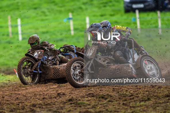 Andy Minard and Lewis Davis (19) and Billy Winterburn and Ryan Wharton (94) battle for second place in the 1000cc Sidecar Class Final during...