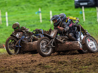 Andy Minard and Lewis Davis (19) and Billy Winterburn and Ryan Wharton (94) battle for second place in the 1000cc Sidecar Class Final during...