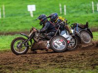 Andy Minard and Lewis Davis (19) and Billy Winterburn and Ryan Wharton (94) battle for second place in the 1000cc Sidecar Class Final during...