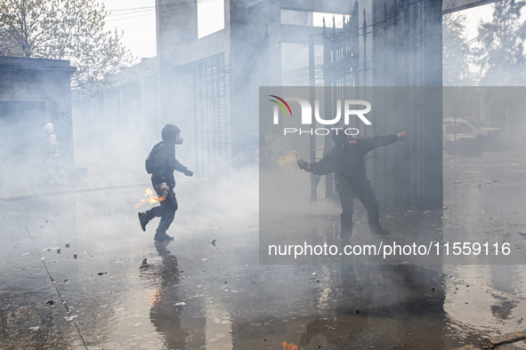 Demonstrators clash with police at the General Cemetery in Chile on September 8, 2024, at the end of the traditional pilgrimage commemoratin...