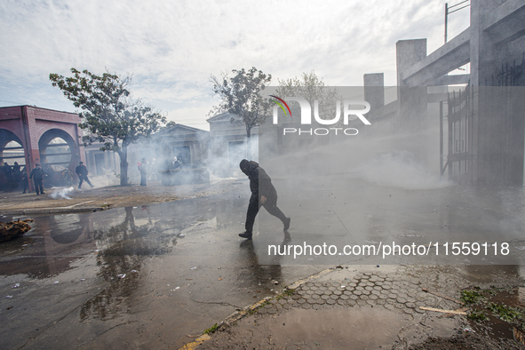 Demonstrators clash with police at the General Cemetery in Chile on September 8, 2024, at the end of the traditional pilgrimage commemoratin...