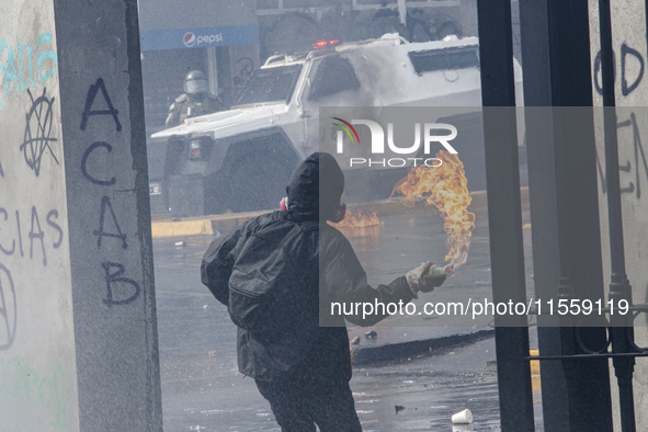 Demonstrators clash with police at the General Cemetery in Chile on September 8, 2024, at the end of the traditional pilgrimage commemoratin...