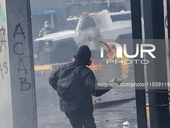 Demonstrators clash with police at the General Cemetery in Chile on September 8, 2024, at the end of the traditional pilgrimage commemoratin...