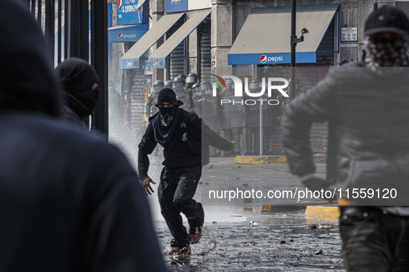 Demonstrators clash with police at the General Cemetery in Chile on September 8, 2024, at the end of the traditional pilgrimage commemoratin...