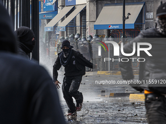 Demonstrators clash with police at the General Cemetery in Chile on September 8, 2024, at the end of the traditional pilgrimage commemoratin...