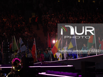 Flag bearers parade with their national flags during the closing ceremony on day eleven of the Paris 2024 Summer Paralympic Games at Stade d...