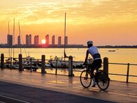 Cyclists ride on Tangdao Bay under the sunrise in Qingdao, China, on September 9, 2024. (