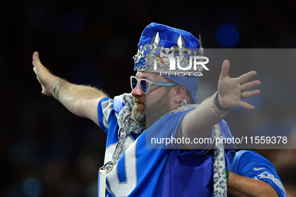 DETROIT,MICHIGAN-SEPTEMBER 9:  A fan in Detroit Lions gear including a crown holds out his arms during a game between the Detroit Lions and...