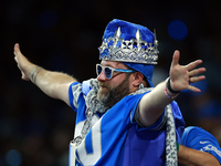 DETROIT,MICHIGAN-SEPTEMBER 9:  A fan in Detroit Lions gear including a crown holds out his arms during a game between the Detroit Lions and...