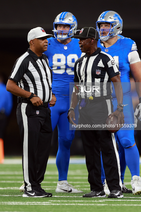 DETROIT,MICHIGAN-SEPTEMBER 9:  Referee Adrian Hill (29) speaks with umpire Roy Ellison (81) during a game between the Detroit Lions and the...