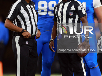 DETROIT,MICHIGAN-SEPTEMBER 9:  Referee Adrian Hill (29) speaks with umpire Roy Ellison (81) during a game between the Detroit Lions and the...