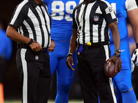 DETROIT,MICHIGAN-SEPTEMBER 9:  Referee Adrian Hill (29) speaks with umpire Roy Ellison (81) during a game between the Detroit Lions and the...