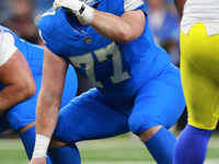 DETROIT,MICHIGAN-SEPTEMBER 8:  Center Frank Ragnow (77) of the Detroit Lions gestures as he prepares to snap the ball during a game between...