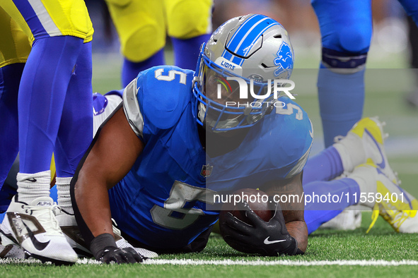 DETROIT,MICHIGAN-SEPTEMBER 8:  Running back David Montgomery (5) of the Detroit Lions holds the ball after being tackled during a game betwe...