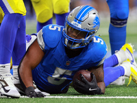 DETROIT,MICHIGAN-SEPTEMBER 8:  Running back David Montgomery (5) of the Detroit Lions holds the ball after being tackled during a game betwe...