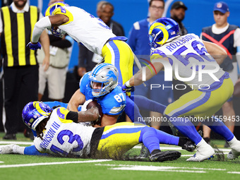 DETROIT,MICHIGAN-SEPTEMBER 8: Tight end Sam LaPorta (87) of the Detroit Lions is tackled by linebacker Christian Rozeboom (56) of the Los An...