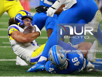 DETROIT,MICHIGAN-SEPTEMBER 8: Los Angeles Rams wide receiver Puka Nacua (17) is tackled by Detroit Lions linebacker Jack Campbell (46) durin...