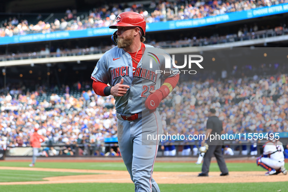 Jake Fraley #27 of the Cincinnati Reds is congratulated after scoring during the seventh inning of the baseball game against the New York Me...