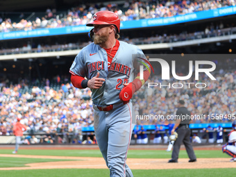 Jake Fraley #27 of the Cincinnati Reds is congratulated after scoring during the seventh inning of the baseball game against the New York Me...