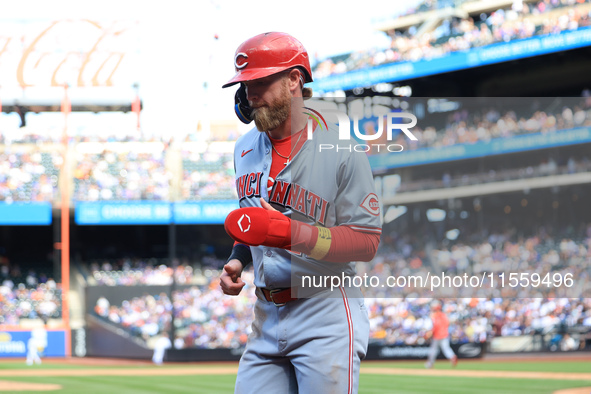 Jake Fraley #27 of the Cincinnati Reds is congratulated after scoring during the seventh inning of the baseball game against the New York Me...