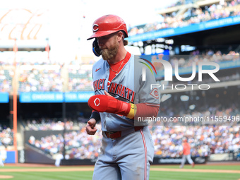 Jake Fraley #27 of the Cincinnati Reds is congratulated after scoring during the seventh inning of the baseball game against the New York Me...