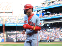 Jake Fraley #27 of the Cincinnati Reds is congratulated after scoring during the seventh inning of the baseball game against the New York Me...