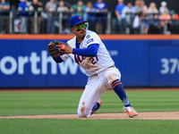 New York Mets third baseman Mark Vientos #27 fields and throws to first base during the ninth inning of the baseball game against the Cincin...