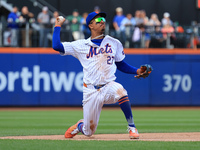 New York Mets third baseman Mark Vientos #27 fields and throws to first base during the ninth inning of the baseball game against the Cincin...