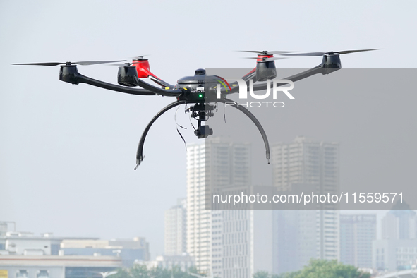 A police drone patrols over the city of Yantai in Yantai, China, on August 9, 2024. According to the Ministry of Industry and Information Te...