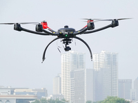 A police drone patrols over the city of Yantai in Yantai, China, on August 9, 2024. According to the Ministry of Industry and Information Te...