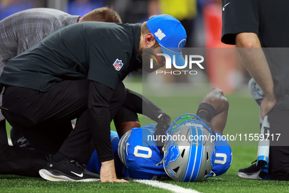 DETROIT,MICHIGAN-SEPTEMBER 8:  Cornerback Terrion Arnold (0) of the Detroit Lions is checked for injury during a game between the Detroit Li...