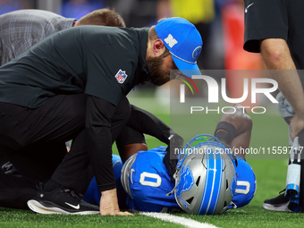 DETROIT,MICHIGAN-SEPTEMBER 8:  Cornerback Terrion Arnold (0) of the Detroit Lions is checked for injury during a game between the Detroit Li...