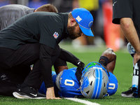 DETROIT,MICHIGAN-SEPTEMBER 8:  Cornerback Terrion Arnold (0) of the Detroit Lions is checked for injury during a game between the Detroit Li...