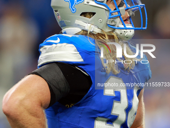 DETROIT,MICHIGAN-SEPTEMBER 8:  Linebacker Alex Anzalone (34) of the Detroit Lions looks up to the screen between plays during a game between...